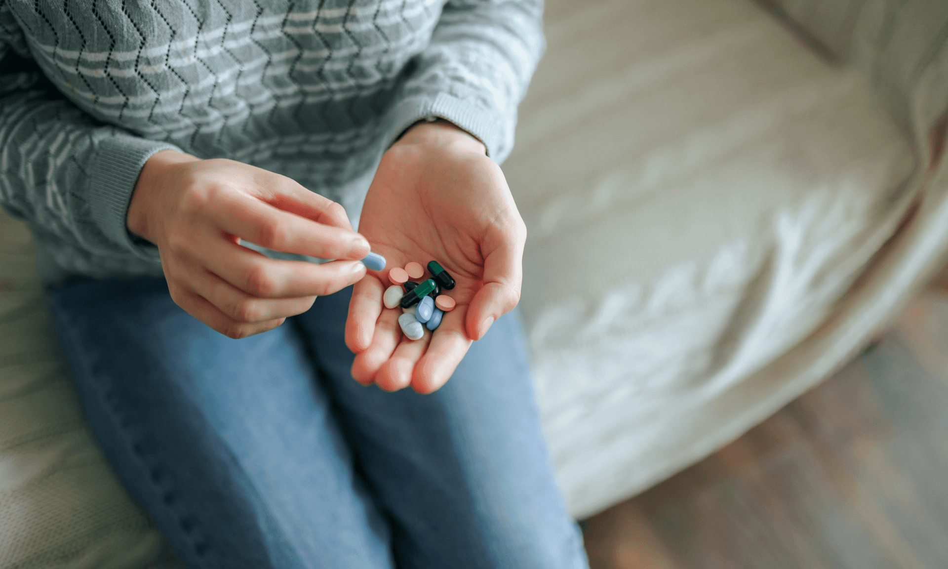 A woman holding a handful of pills