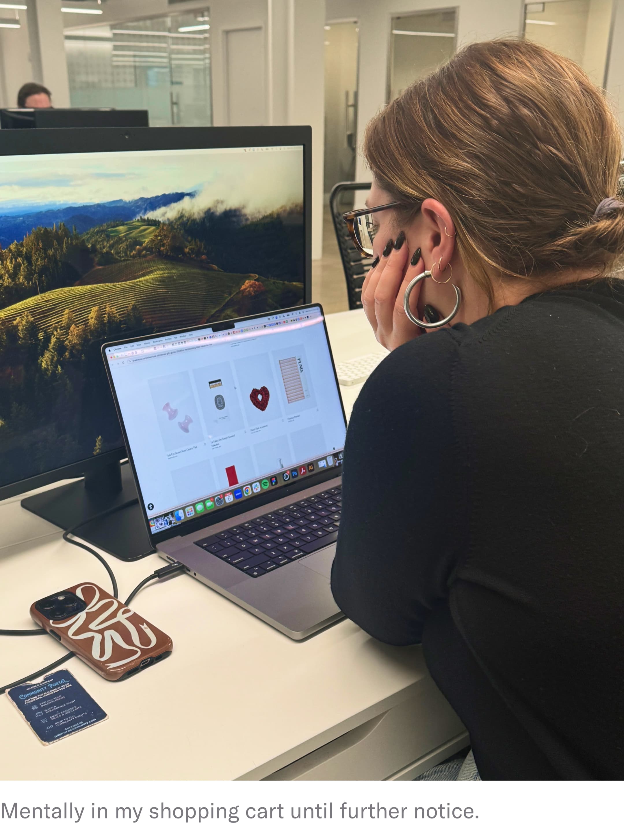 woman looking at laptop on desk