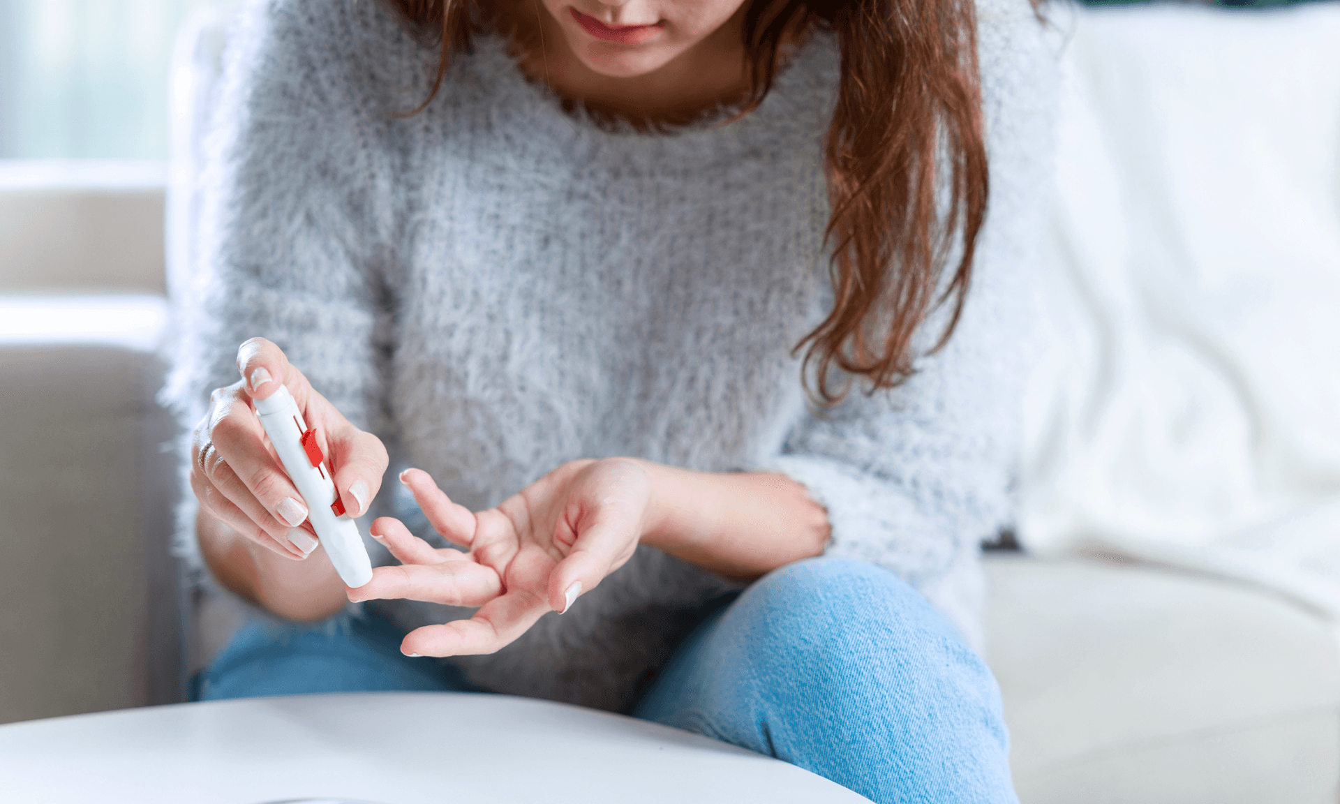 A woman doing a finger-prick