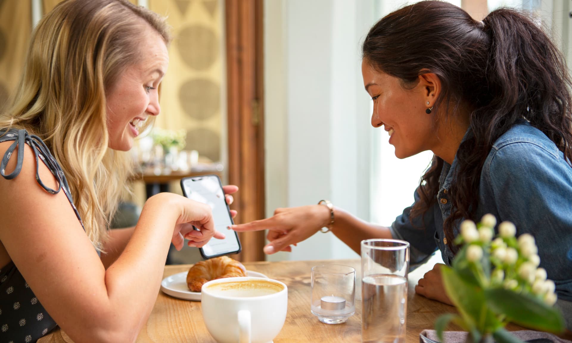women looking at their phones