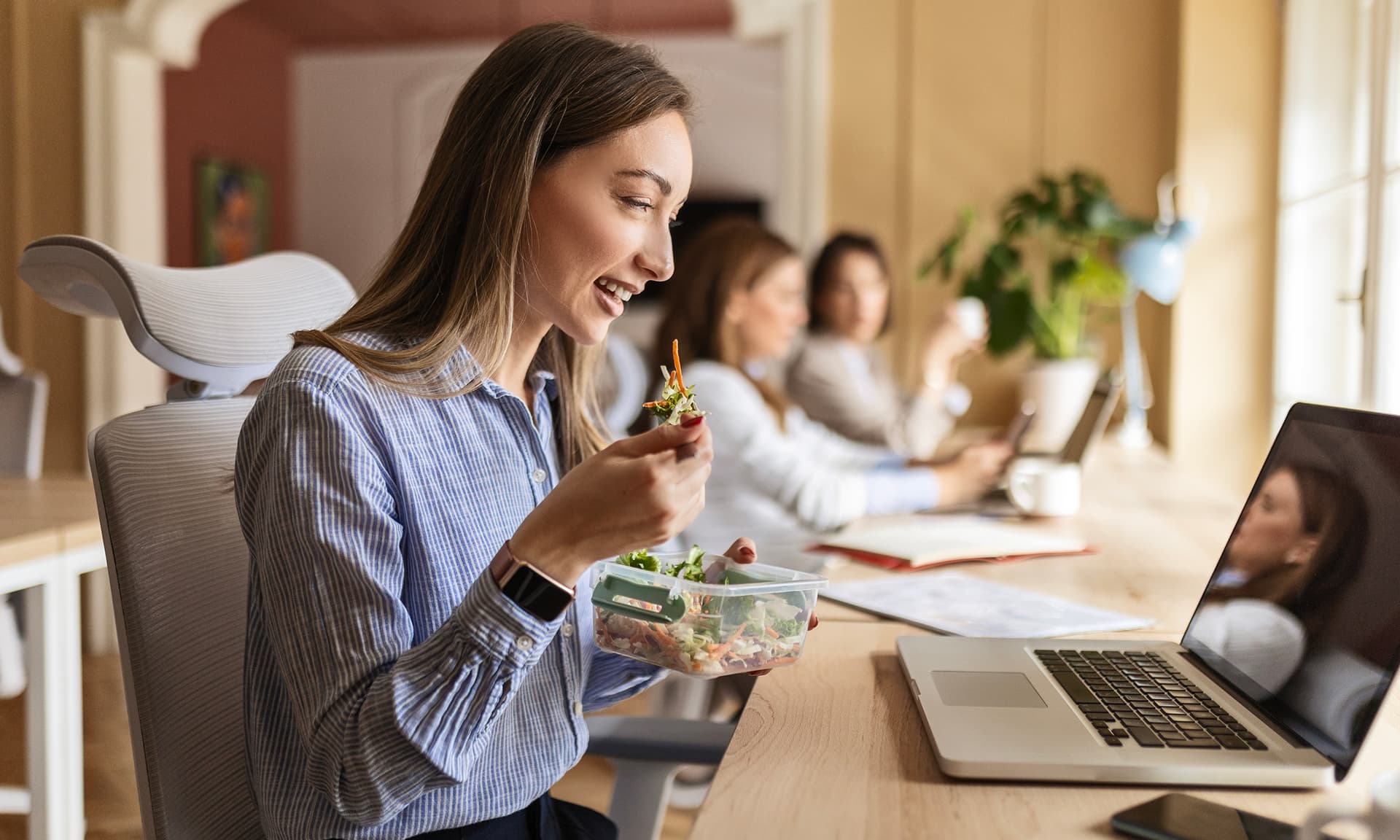 Woman eating lunch at desk