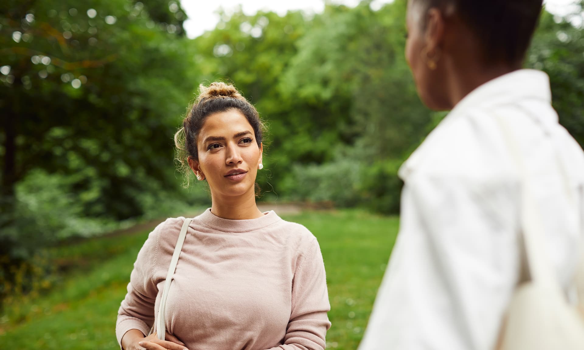 Two friends talking in a park